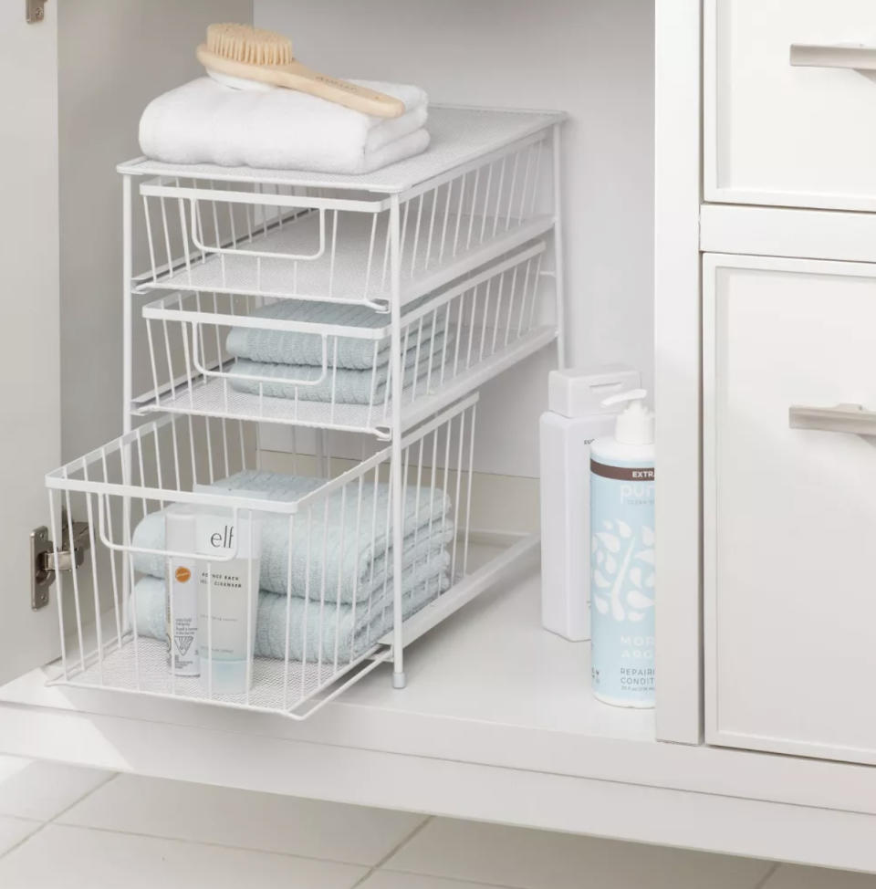 A three tier drawer organizer in a cabinet