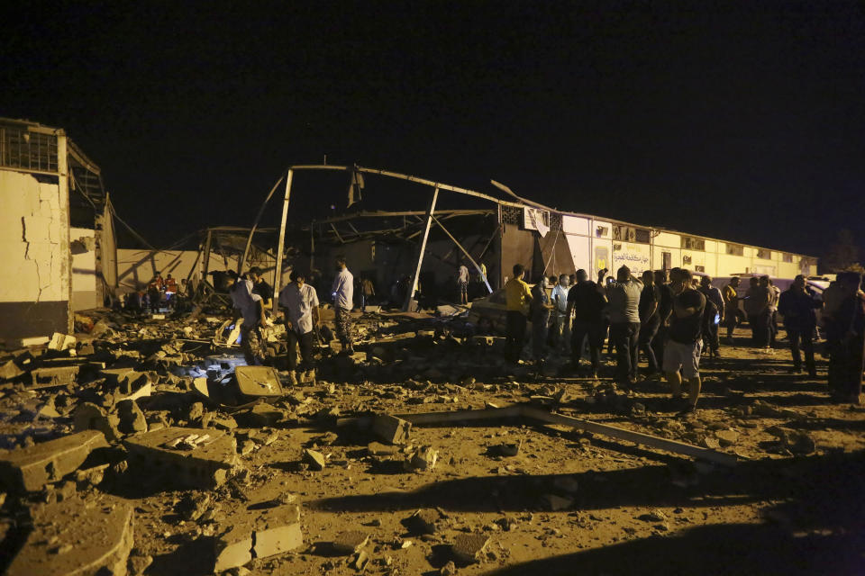 Libyan Red Crescent workers recover migrants bodies after an airstrike at a detention center in Tajoura, east of Tripoli Wednesday, July 3, 2019. An airstrike hit the detention center for migrants early Wednesday in the Libyan capital. (AP Photo/Hazem Ahmed)