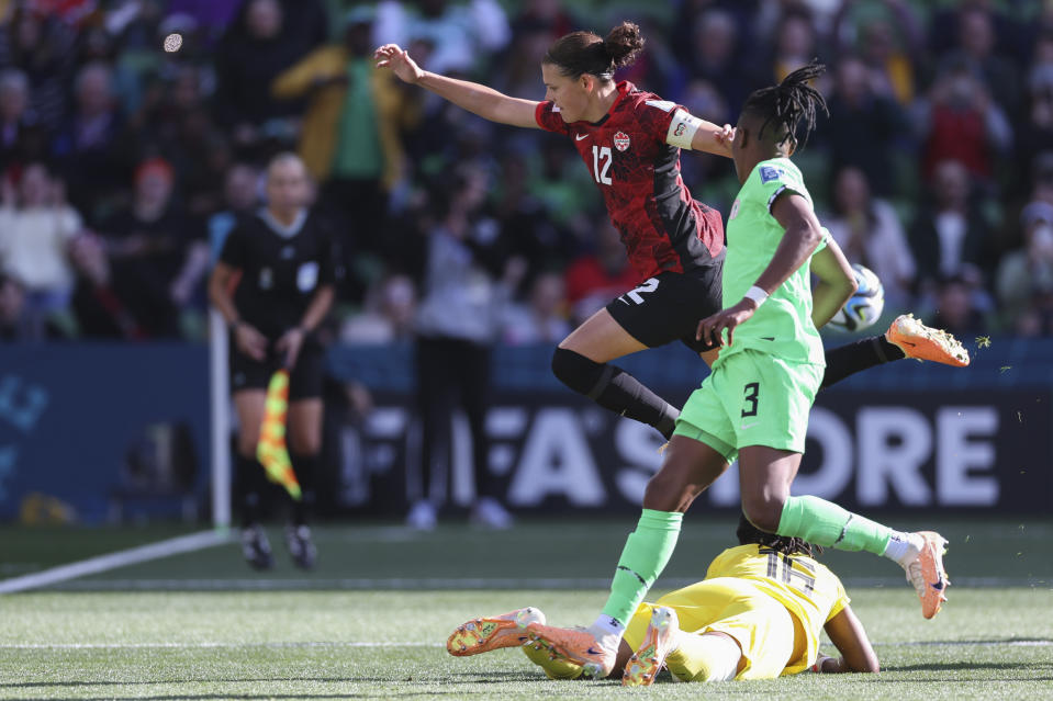 Canada's Christine Sinclair leaps over Nigeria's goalkeeper Chiamaka Nnadozie after trying to follow up on a penalty kick during the Women's World Cup Group B soccer match between Nigeria and Canada in Melbourne, Australia, Friday, July 21, 2023. (AP Photo/Victoria Adkins)