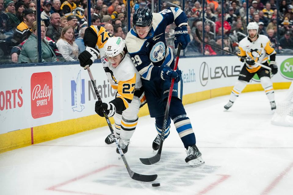Nov 14, 2023; Columbus, Ohio, USA; Columbus Blue Jackets right wing Patrik Laine (29) fights for the puck with Pittsburgh Penguins defenseman Ryan Graves (27) during the third period of the NHL hockey game at Nationwide Arena. The Blue Jackets lost 5-3.