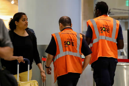 Air Alaska maintenance workers walk through the the terminal, following an incident where an airline employee took off in an airplane, at Seattle-Tacoma International Airport in Seattle, Washington, U.S., August 10, 2018. REUTERS/Brendan McDermid