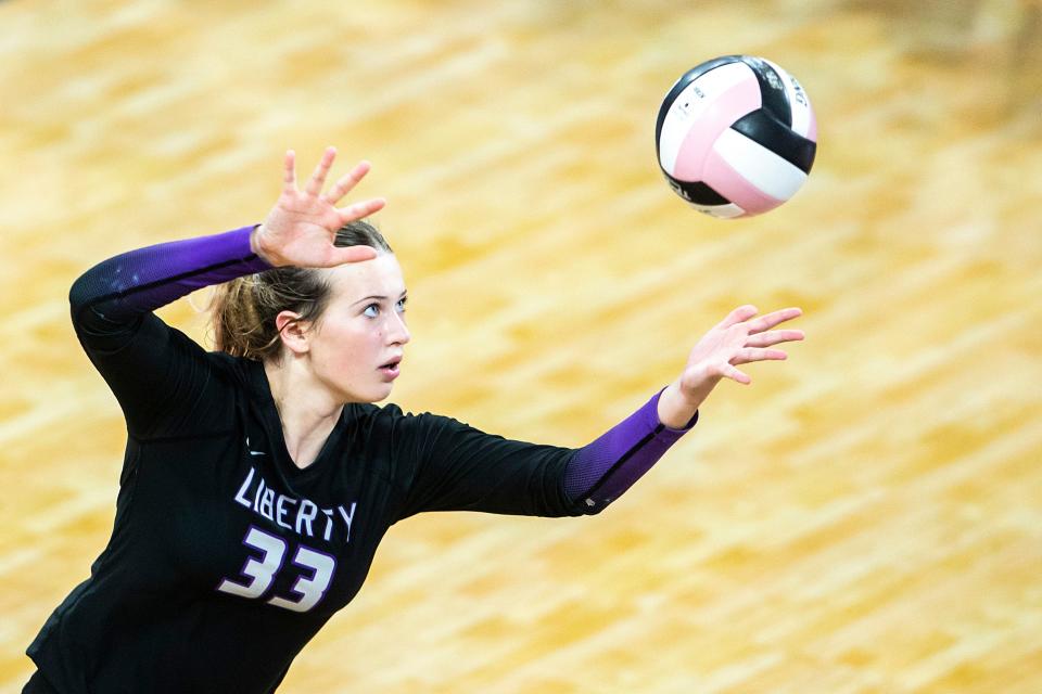 Iowa City Liberty's Cassidy Hartman (33) serves during a Class 5A state volleyball championship match