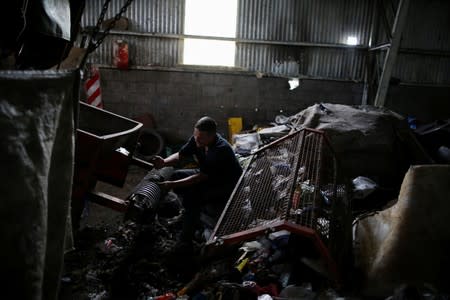 A waste picker works at the state entity CEAMSE in the neighborhood of Jose Leon Suarez, on the outskirts of Buenos Aires