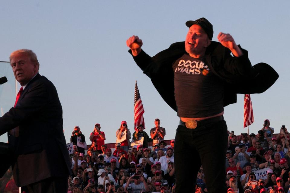 One picture from the event shows Elon Musk in the middle of a little half-hop while Trump looks on like a disappointed father (Reuters)