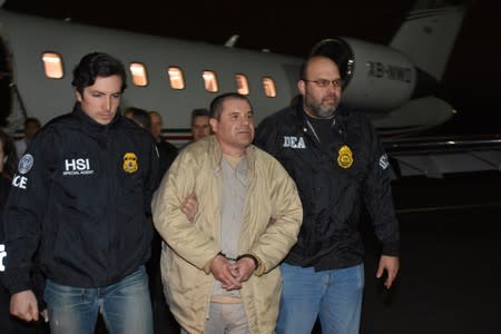 Mexico's top drug lord Joaquin "El Chapo" Guzman is escorted as he arrives at Long Island MacArthur airport in New York