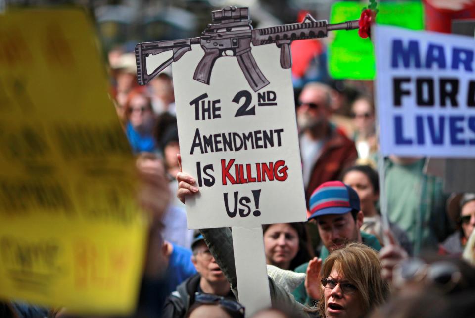 Protestors hold signs during a "March For Our Lives" demonstration demanding gun control in Sacramento, California, U.S. March 24, 2018.