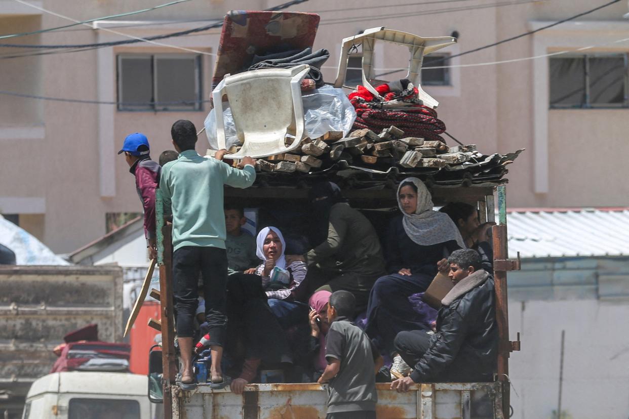 Dozens of Palestinians flee Rafah with their belongings in the back of a truck ahead of a long-anticipated Israeli invasion of the area (REUTERS)