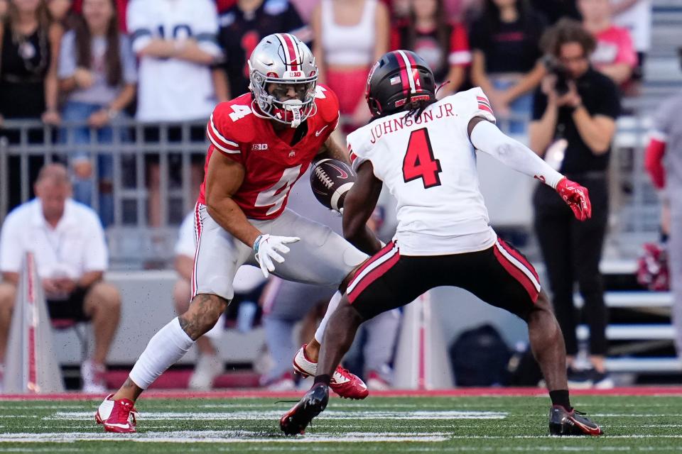 Ohio State receiver Julian Fleming runs toward Western Kentucky defensive back Anthony Johnson Jr.