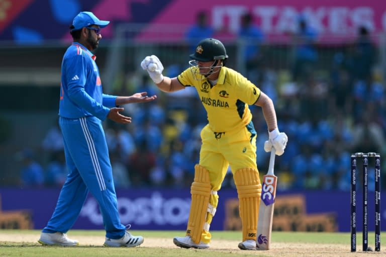 Ball boys: Australia's David Warner gives the ball to India captain Rohit Sharma on Sunday (R.Satish BABU)