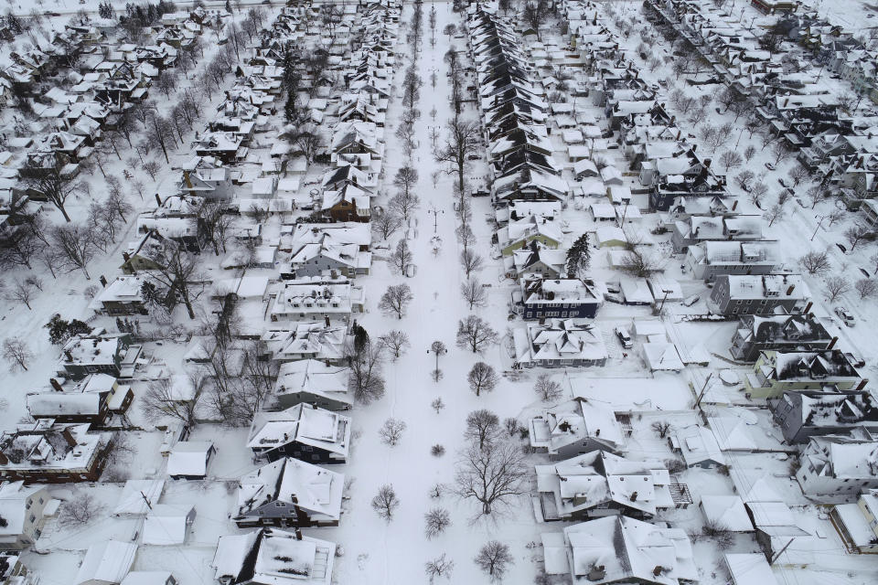 Fordham Avenue, center, and the 1901 Pan-American Exposition neighborhood of Buffalo, N.Y. is coated in a blanket of snow after the blizzard, Tuesday, Dec. 27, 2022. State and military police were sent Tuesday to keep people off Buffalo’s snow-choked roads, and officials kept counting fatalities three days after western New York’s deadliest storm in at least two generations. (Derek Gee /The Buffalo News via AP)