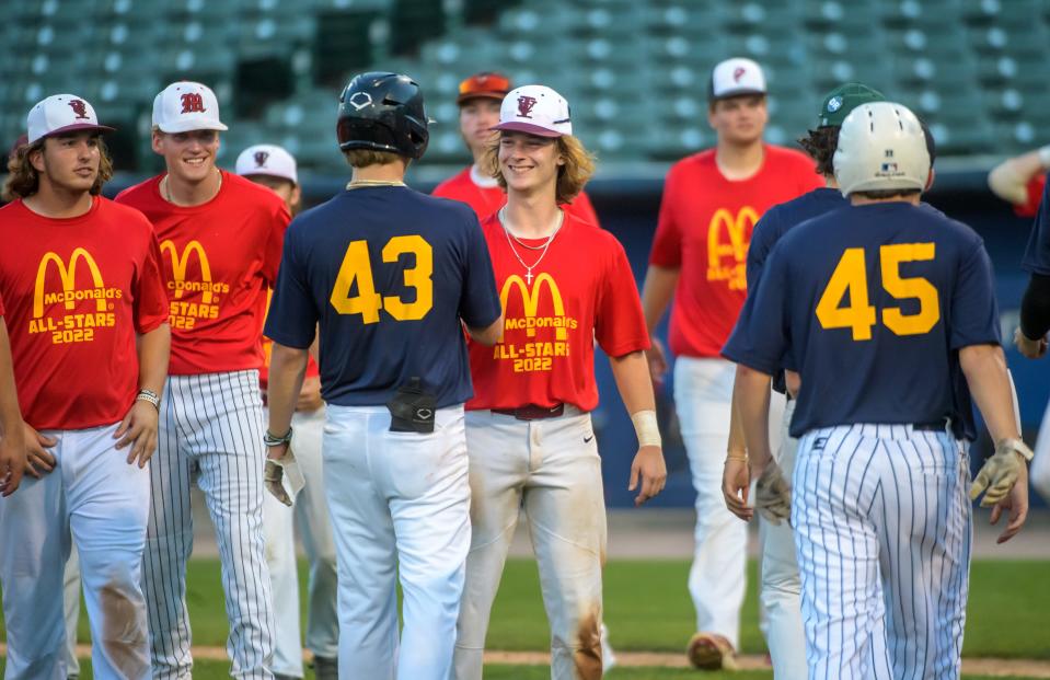 East and West player shake hands after the McDonald's All-Star Game on Tuesday, June 21, 2022 at Dozer Park. The East Team, in red, defeated the West Team 14-9.