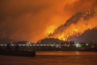 <p>This Monday, Sept. 4, 2017, photo provided by KATU-TV shows a wildfire as seen from near Stevenson Wash., across the Columbia River, burning in the Columbia River Gorge above the Bonneville Dam near Cascade Locks, Ore. (Photo: Tristan Fortsch/KATU-TV via AP) </p>