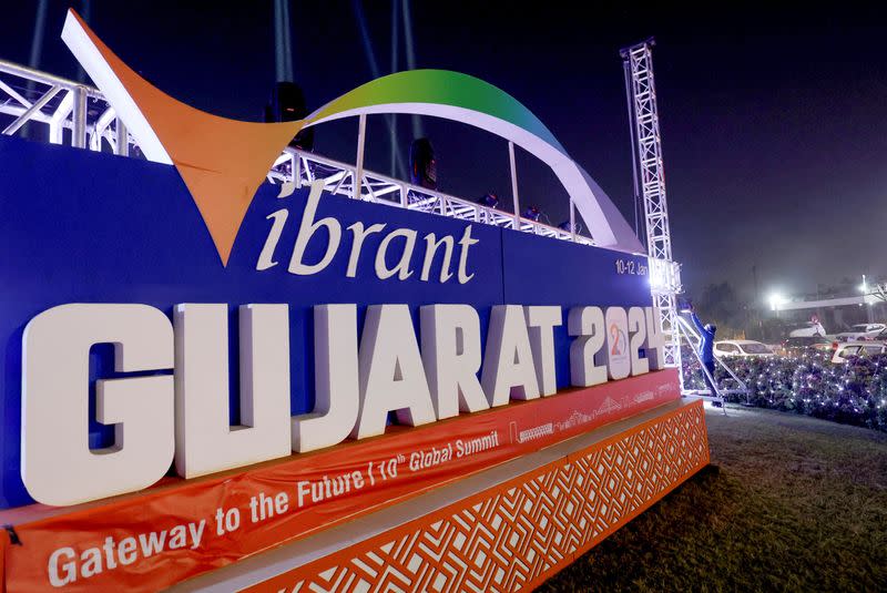 A worker installs lights ahead of the Vibrant Gujarat Global Summit, in Ahmedabad