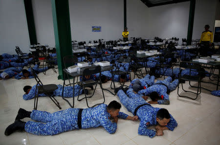 Participant of the Bela Negara - "defend the nation" - program are forced onto the floor by military trainers while eating breakfast at a training centre in Rumpin, Bogor, West Java, Indonesia. REUTERS/Darren Whiteside