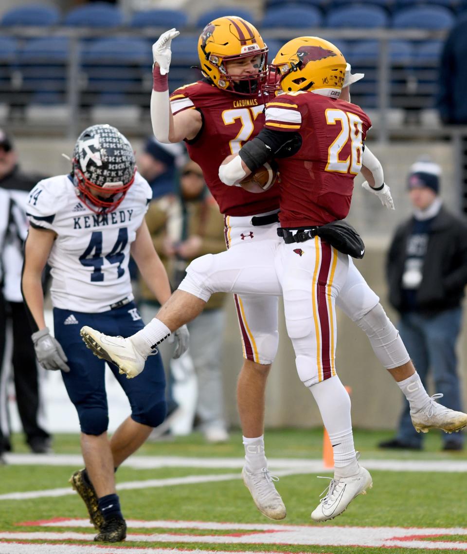 New Bremen's Hunter Schaefer, right, celebrates his first-quarter touchdown with Ben Sailer, left,  vs. Warren JFK in the OHSAA Division VII state final at Tom Benson Hall of Fame Stadium. Saturday, Dec. 3, 2022.