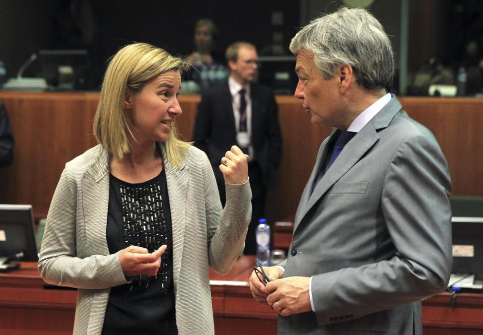 Italy's Foreign Minister Federica Mogherini, left, talks with Belgium's Foreign Minister Didier Reynders during an EU foreign ministers meeting at the European Council building in Brussels Monday, May 12, 2014. EU foreign ministers discuss the situation in Ukraine. (AP Photo/Yves Logghe)