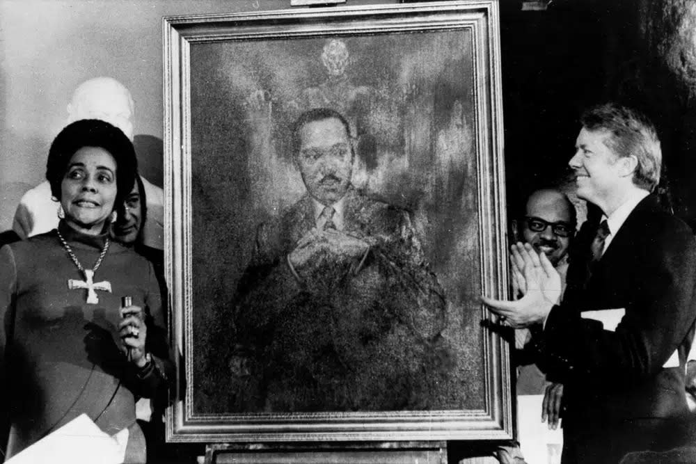 Coretta Scott King, widow of slain civil rights leader Martin Luther King Jr., speaks at an unveiling of a portrait of King by artist George Mandus, Feb. 18, 1974, and dedicated by Gov. Jimmy Carter. (AP Photo/File)