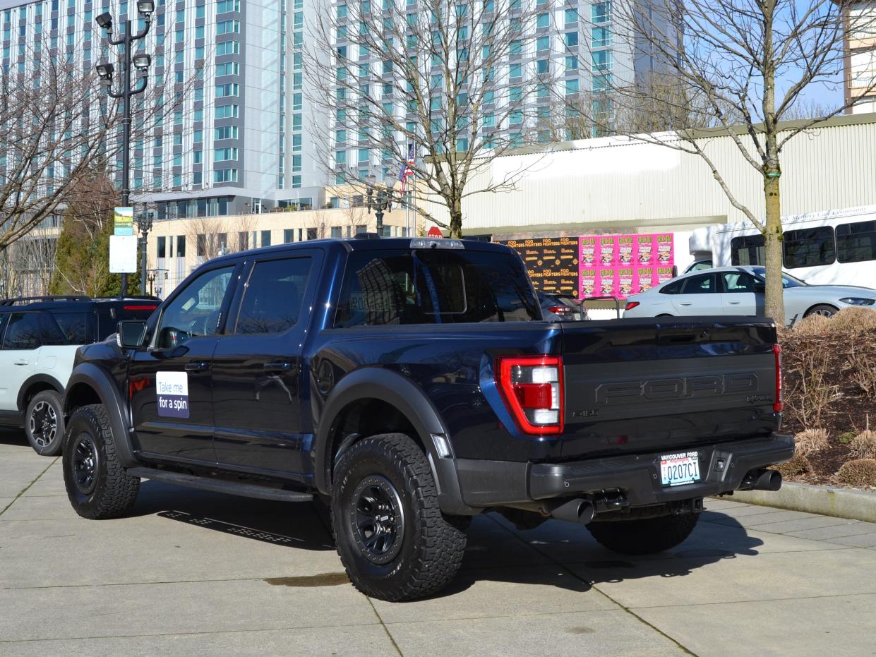 a navy 2024 Ford F-150 Raptor from behind
