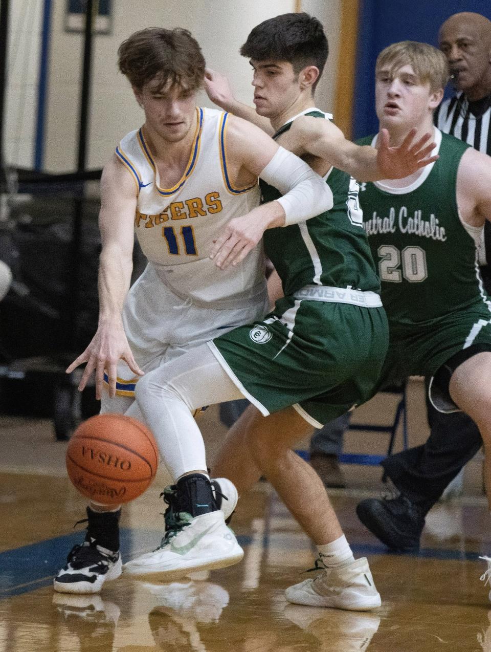 Lake Center Christian’s Ethan Bower (11) tries to get by Central Catholic’s Ethan Ragon on Tuesday, Jan. 18, 2022.