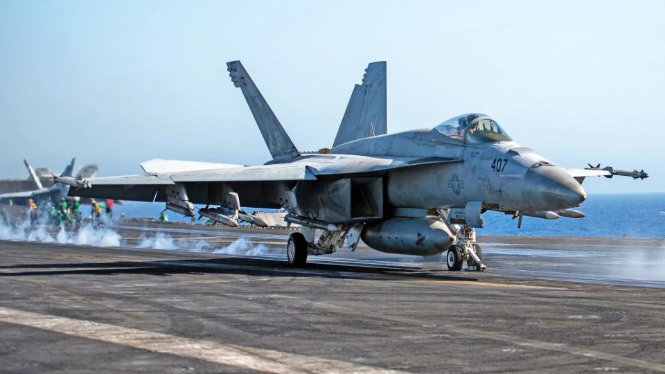 One of Ike’s F/A-18E Super Hornets launches with a full air-to-air loadout of five AIM-120s and four AIM-9Xs. <em>USN</em>