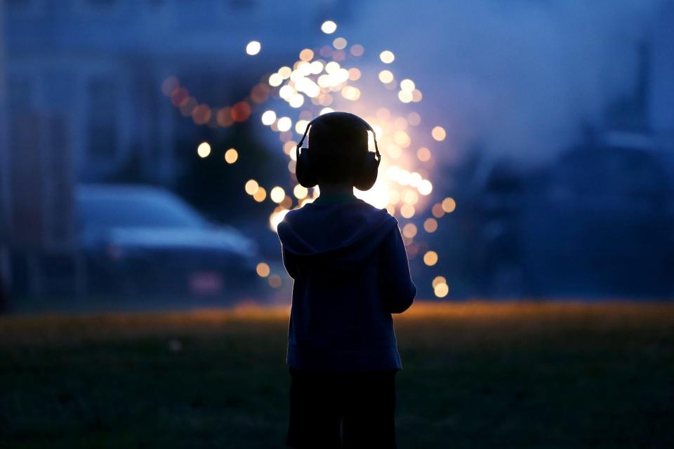 Kids enjoy fireworks in a backyard before Portsmouth's fireworks show Monday, July 5, 2021 in celebration of the Fourth of July.