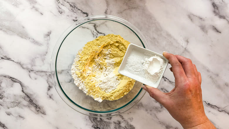 dry cornbread ingredients going into bowl