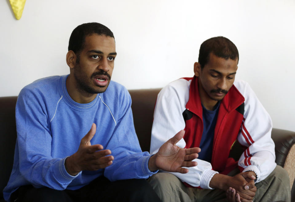 FILE - In this March 30, 2018, file photo, Alexanda Amon Kotey, left, and El Shafee Elsheikh, who were allegedly among four British jihadis who made up a brutal Islamic State cell dubbed "The Beatles," speak during an interview with The Associated Press at a security center in Kobani, Syria. Kotey, a British national admitted Thursday evening, Sept. 2, 2021 in a federal courtroom near the nation's capital that he played a leadership role in an Islamic State scheme to torture, hold for ransom and eventually behead American hostages. (AP Photo/Hussein Malla, File)