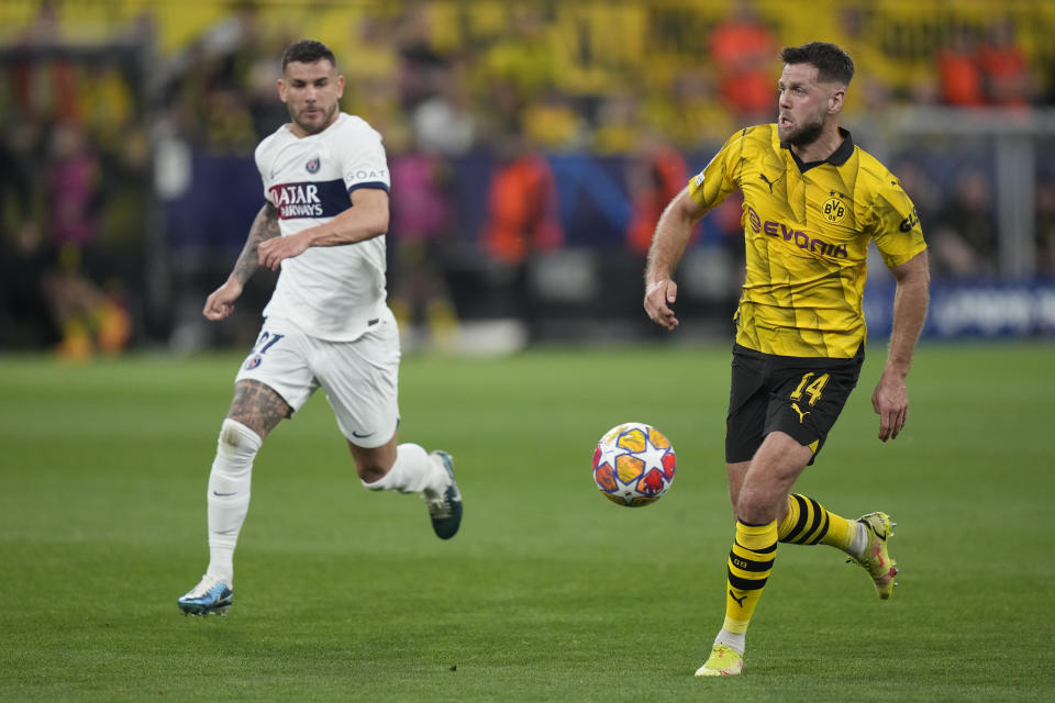 Dortmund's Niclas Fuellkrug, right, is challenged by PSG's Lucas Hernandez during the Champions League semifinal first leg soccer match between Borussia Dortmund and Paris Saint-Germain at the Signal-Iduna Park stadium in Dortmund, Germany, Wednesday, May 1, 2024. (AP Photo/Matthias Schrader)