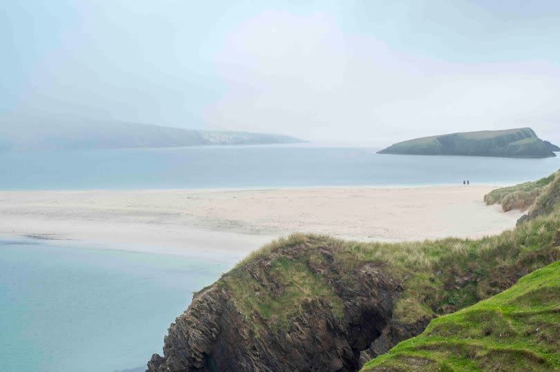 View over sandbar in the mist from St Ninian's Isle, largest tombolo in the UK, Dunrossness, Mainland, Shetland Islands, Scotland, UK.