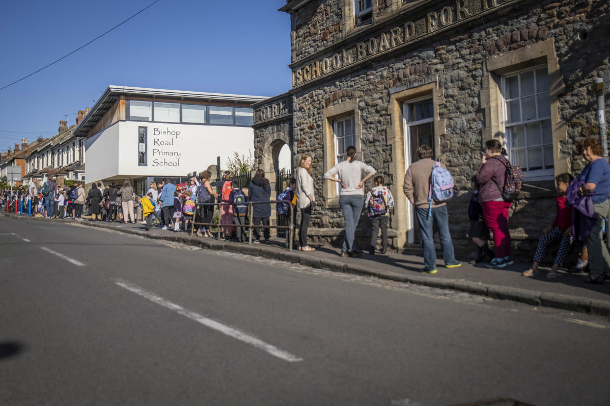 Parents walk their children into Bishop's Road Primary School as schools reopen. Bristol. 1 September 2020.   See SWNS story SWBRschool. Many schools are returning in full for the first time since March.