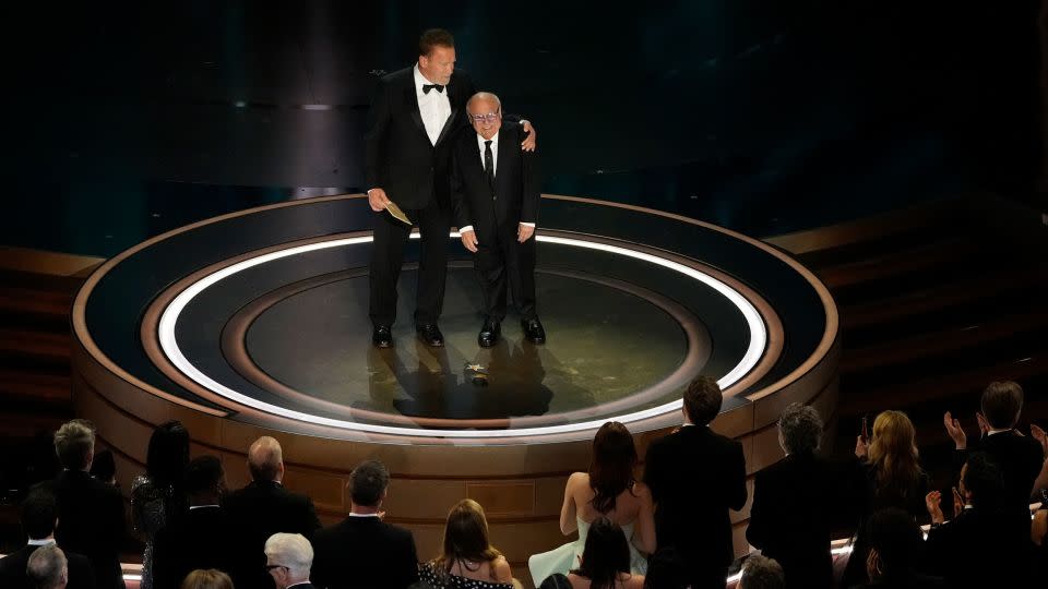 (From left) Arnold Schwarzenegger and Danny DeVito presenting an award at the 2024 Oscars in Hollywood. - Chris Pizzello/Invision/AP