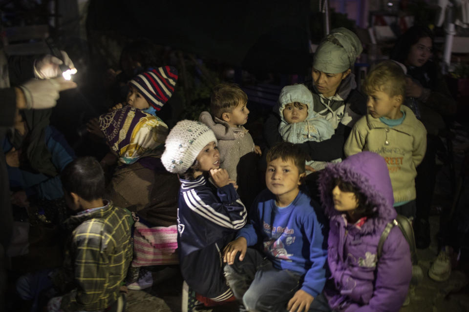 Migrants wait for transport following a rescue operation by a Frontex patrol vessel at the port of Skala Sikamias, on the Greek island of Lesbos early Thursday, Oct. 3, 2019. Migrants most from Afghanistan were rescued by a Frontex patrol vessel as they were trying to cross a part of the Aegean sea, from Turkey to Greece, on a plastic boat. More than 12,000 people — more than four times the site's capacity — are currently housed in the camp of Moria on Lesbos island and just outside its perimeter following a spike in migrant arrivals over the summer. (AP Photo/Petros Giannakouris)