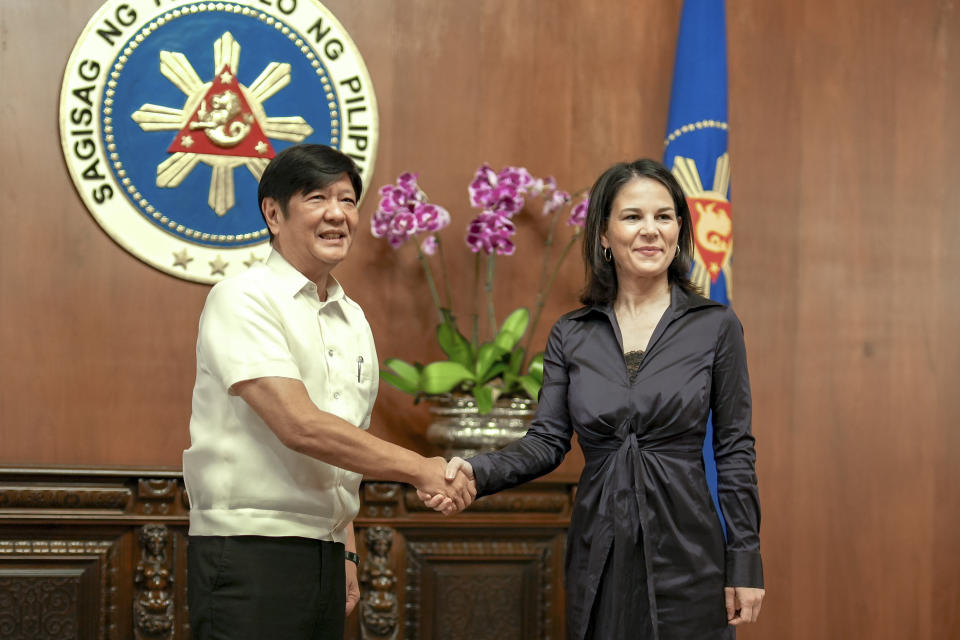 In this handout photo provided by the Malacanang Presidential Communications Office, Philippine President Ferdinand Marcos Jr., left, greets German Foreign Minister Annalena Baerbock during her courtesy call at the Malacanang presidential palace in Manila, Philippines on Thursday Jan. 11, 2024. (Malacanang Presidential Communications Office via AP)