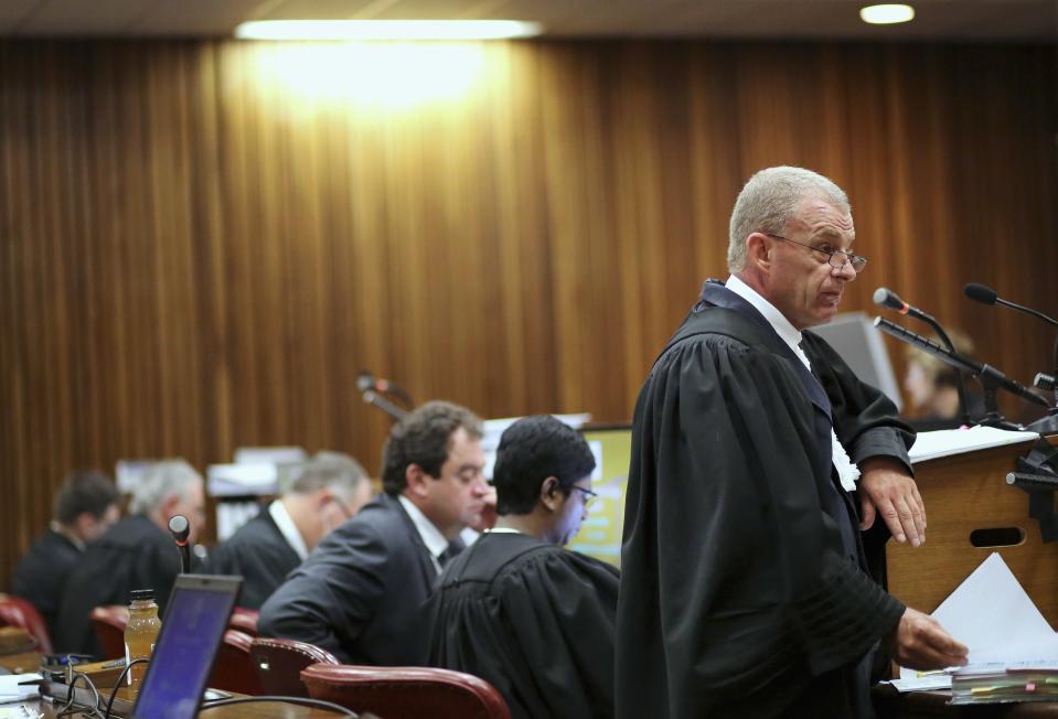 State prosecutor Gerrie Nel (R) makes a point during the trial of Olympic and Paralympic track star Oscar Pistorius, at the North Gauteng High Court in Pretoria, March 17, 2014. Pistorius is on trial for murdering his girlfriend Reeva Steenkamp at his suburban Pretoria home on Valentine's Day last year. He says he mistook her for an intruder. REUTERS/Siphiwe Sibeko (SOUTH AFRICA - Tags: CRIME LAW SPORT ATHLETICS)