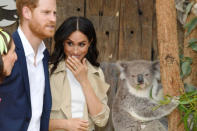 Britain's Prince Harry, the Duke of Sussex, and his wife Meghan, the Duchess of Sussex, are seen meeting Ruby, a mother Koala who gave birth to koala joey Meghan, named after Her Royal Highness, with a second joey named Harry after His Royal Highness, during a visit to Taronga Zoo in Sydney, Australia, October 16, 2018. AAP/Dominic Lipinski/POOL/via REUTERS