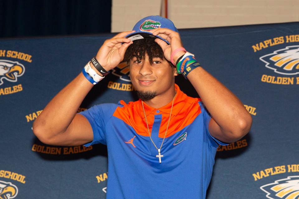Naples’ Devin Moore announces his commitment to play college football at Florida, Wednesday, Dec. 15, 2021, at Naples High School in Naples, Fla.