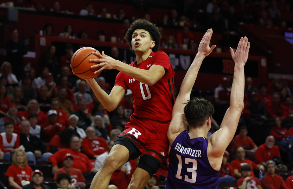 Rutgers guard Derek Simpson (0) drives to the basket against Northwestern guard Brooks Barnhizer (13) during the second half of an NCAA college basketball game, Sunday, March 5, 2023, in Piscataway, N.J. Northwestern won 65-53. (AP Photo/Noah K. Murray)