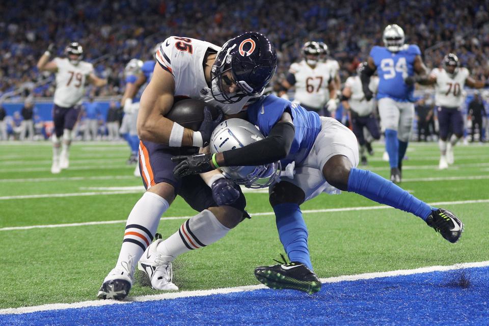Bears tight end Cole Kmet (left) scores a touchdown as Lions safety Kerby Joseph tries to stop him during the first quarter at Ford Field on Jan. 1, 2023 in Detroit.
