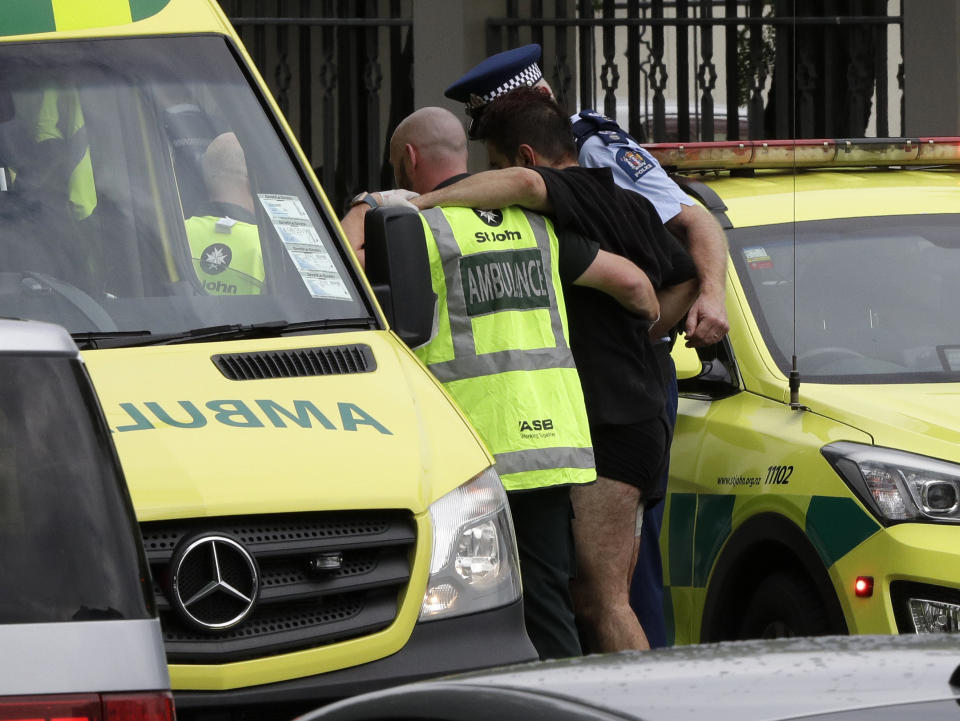 Police and ambulance staff help a wounded man from outside a mosque in central Christchurch, New Zealand, Friday, March 15, 2019.  (Photo: Mark Baker/AP)