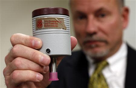 Craig Healy, the U.S. government's chief law enforcement officer for counter-proliferation, holds up a seized pressure transducer used in uranium enrichment, in his office at the Export Enforcement Coordination Center in Northern Virginia November 21, 2013. The "E2C2" unit is a joint Homeland Security/FBI/Commerce operation. REUTERS/Kevin Lamarque