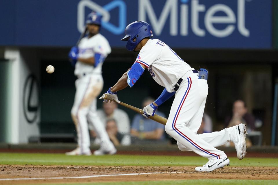 Texas Rangers' Bubba Thompson bunts for a single in the seventh inning of the team's baseball game against the Chicago White Sox, Thursday, Aug. 4, 2022, in Arlington, Texas.(AP Photo/Tony Gutierrez)