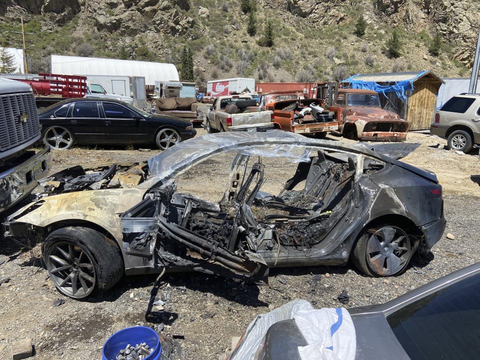 This image provided by Colorado State Patrol shows a Tesla Model 3 that crashed on May 16, 2022 in Clear Creek County, Colo. The widow of a man who died after his Tesla veered off the road and crashed into a tree while he was using its partially automated driving system in Colorado in 2022 is suing the car maker, claiming its marketing of the technology is dangerously misleading. The Autopilot system prevented Hans Von Ohain from being able to keep his Model 3 Tesla on the road and he died after the car burst into flames after hitting the tree, according to the lawsuit filed by Nora Bass in Colorado state court on May 3, 2024. A passenger was able to escape, it said. (Colorado State Patrol via AP)