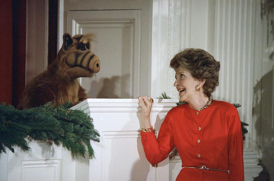 Nancy Reagan shares a moment with ALF during a children's Christmas party at the White House.