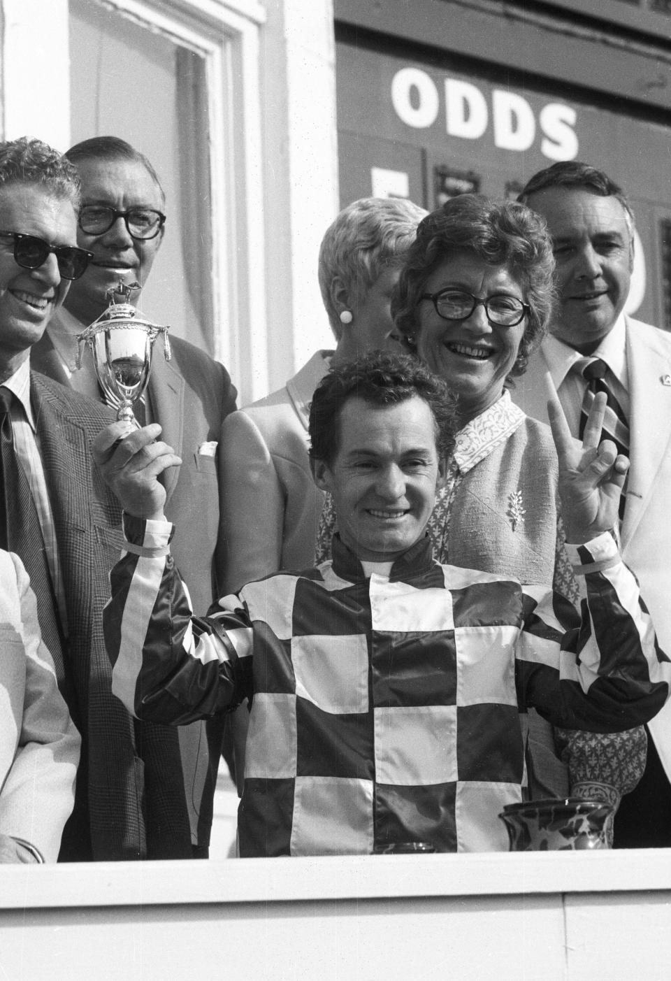 Ron Turcotte holds up his trophy after winning the 99th Kentucky Derby abroad Secretariat at Churchill Downs.