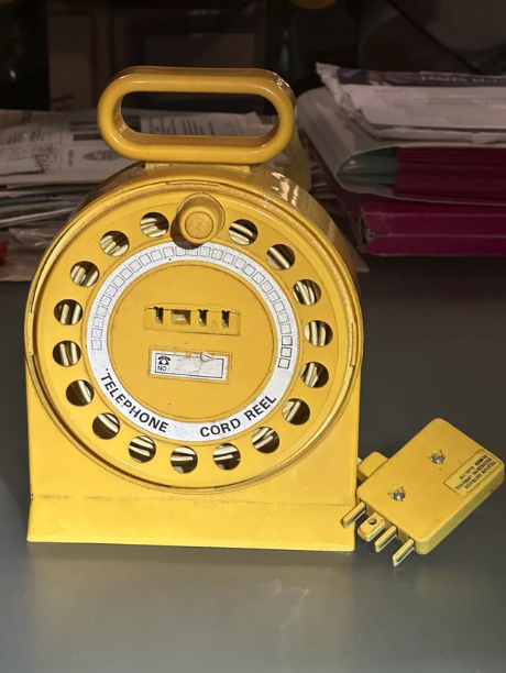 Telephone cord reel on a table