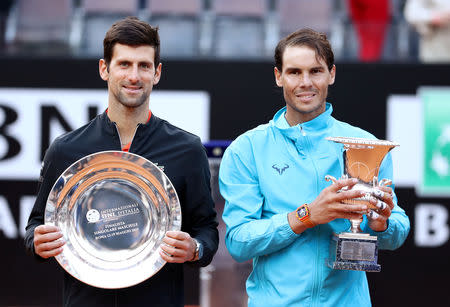 Tennis - ATP 1000 - Italian Open - Foro Italico, Rome, Italy - May 19, 2019 Spain's Rafael Nadal celebrates winning the final against Serbia's Novak Djokovic as they pose with their respective winner and runner up trophies REUTERS/Matteo Ciambelli