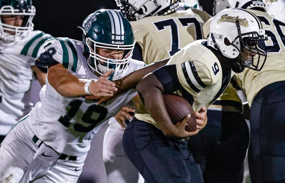 Greenbrier's Nathan Robinson (19) grabs Springfield's Keenan Chatman Jr (9) during their game Friday, Aug. 20, 2021, in Springfield, Tenn. 