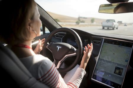 FILE PHOTO - New Autopilot features are demonstrated in a Tesla Model S during a Tesla event in Palo Alto, California October 14, 2015. REUTERS/Beck Diefenbach/File Photo