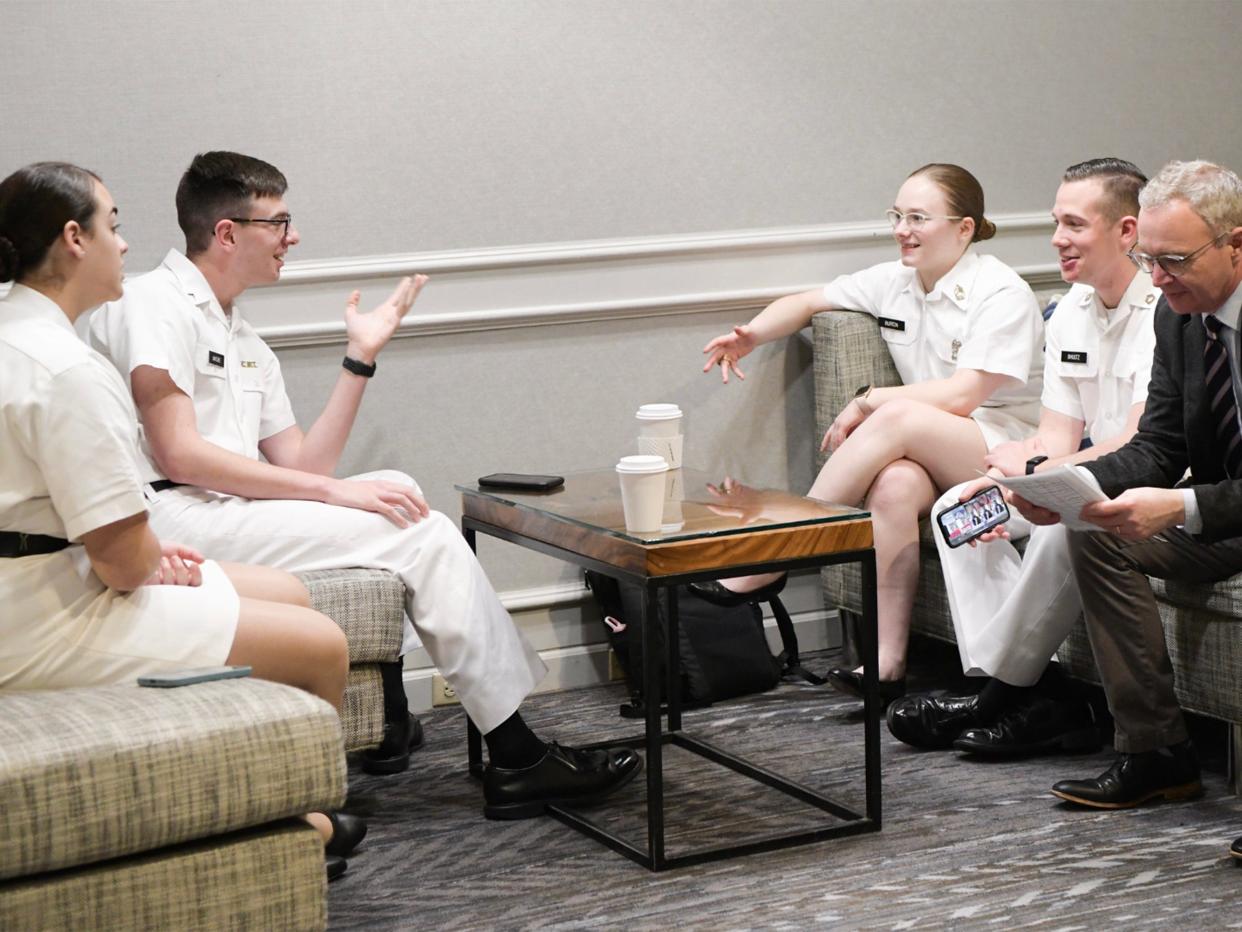 VMI ethics and debate team members Gabriele Woodward ’24, and Riley Malone ’25, Harris Burton ’23, and Riley Shultz ’24 discuss strategy with their coach, Dr. Duncan Richter.