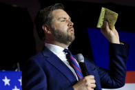 FILE - Republican Senate candidate JD Vance holds a piece of paper with the name of former President Donald Trump written on it, as he speaks May 3, 2022, in Cincinnati. (AP Photo/Aaron Doster, File)